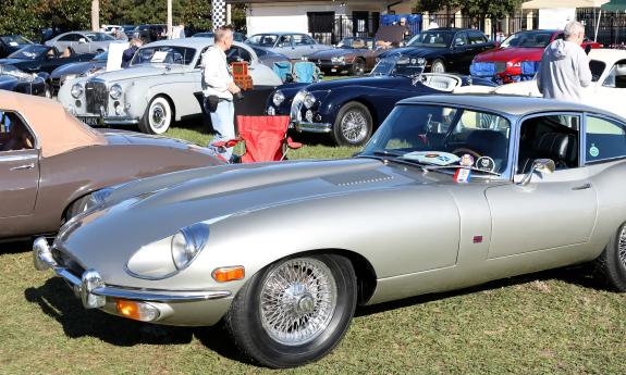 A sleek silver sport car at an outdoor auto show