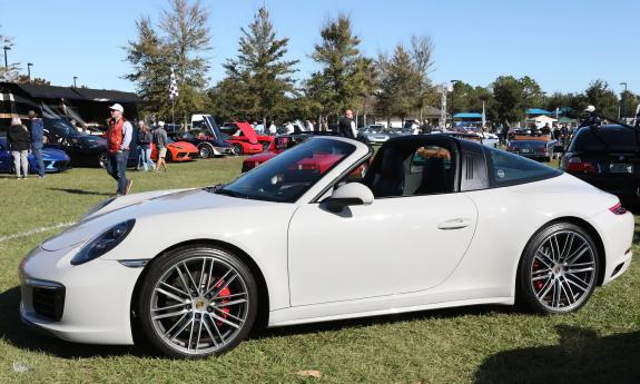 A white sport car at an outdoor auto show