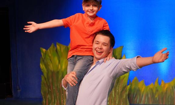 The cast onstage in costumes for the musical production of Big Fish at Limelight Theatre. 