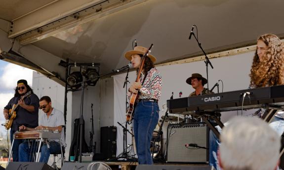 The band, Patsy's Day Dream performing on an outdoor stage, with a white background and cover