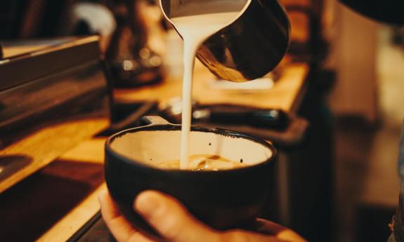 A barista at one of St. Augustine's Kookaburra coffee shops, preparing a hot drink for a guest