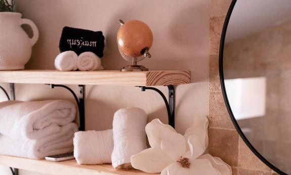 A simple arrangement of white towels and toiletries in the room of a renovated inn