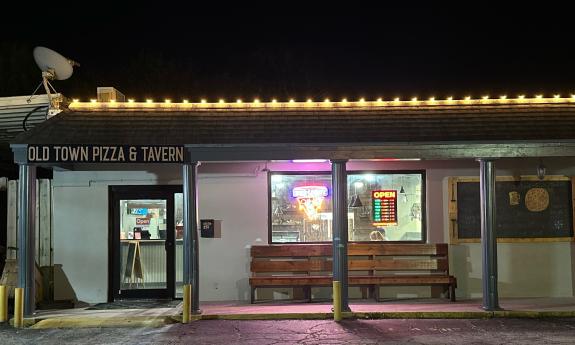 The exterior of Old Town Pizza at night