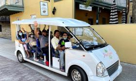 A family group taking a tour aboard an electric vehicle by Pineapple Tours in St. Augustine