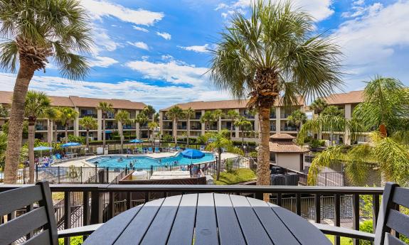 A view from the deck of a condominium, overlooking the pool