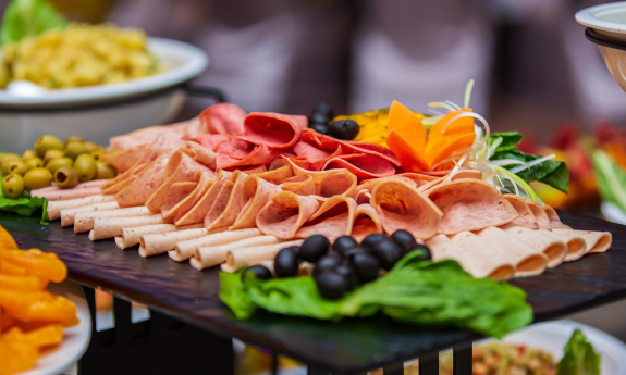 Charcuterie is splayed on a platter. 