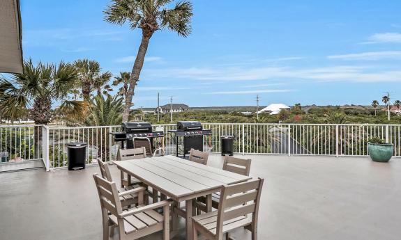 A roof-top deck, with tables and grills, and overlooking the ocean and the IWW