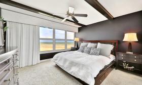 A master bedroom with a beach view