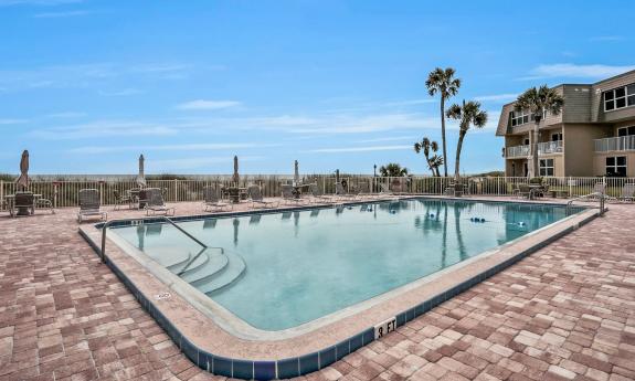 The pool deck at a condo complex on the beach