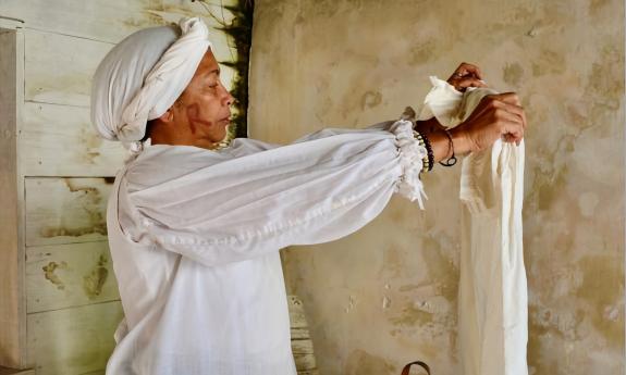 A woman acting as a servant doing laundry at the Ximenez-Fatio House Museum