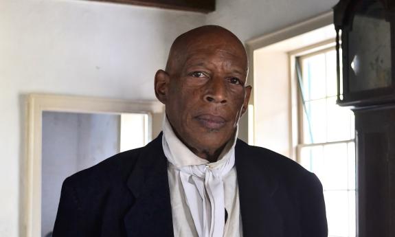 An actor portraying the role of servant in the Ximenez-Fatio House Museum