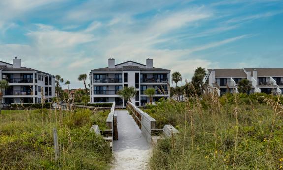 The path to the ocean beach with a view of the condominiums 