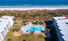 An aerial view of Colony Reef Club, with its pools, next to the beach in St. Augustine