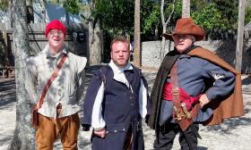 Three men, garbed in 16th century clothing and gear