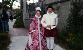 A couple garbed in colonial Spanish clothing standing in the Radzinski Garden