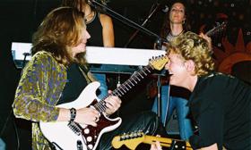 Vange Durst playing guitar with Robert Urban.