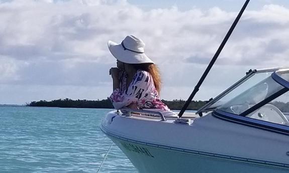 A guest watches the water from an Adventure in Paradise cruise.