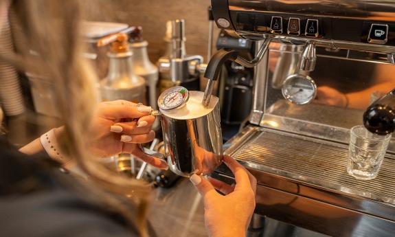 A barista preparing Ellianos coffee.