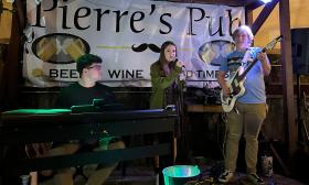 A trio of musicians performing at Pierre's Pub