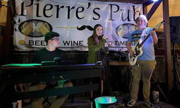 A trio of musicians performing at Pierre's Pub