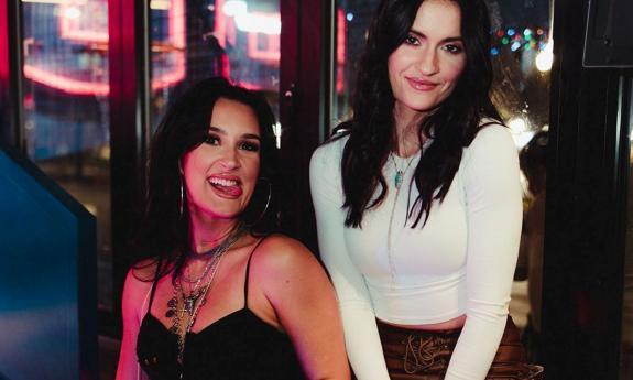 Presley and Taylor smile playfully for the camera. 