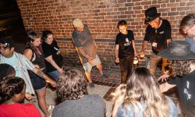 A tour with Junket and US Ghost Tours, with guests and guides in a circle