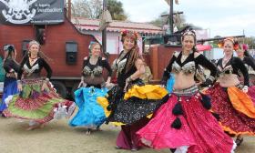 The Swashbucklers pirate troop includes dancers in colorful dresses