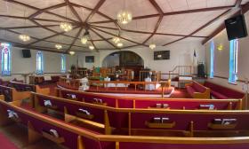 The interior of St. Paul AME Church, with the altar in the background and pews in the foreground