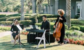 Musicians on violin, keyboards, and cello performing as Jaxstrings