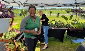 A smiling woman clearly enjoying the flower and garden show