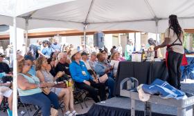 A cooking demo, under the tent at the St. Augustine Food and Wine Festival in 2022