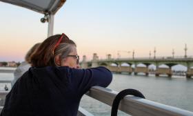 A woman viewing the Bridge of Lions from the deck of The St. Augustine Boat Tours