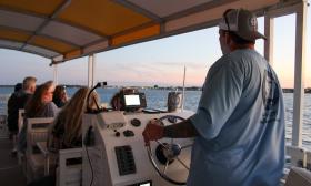Captain Sean driving this vessel for a St. Augustine Boat Tours sunset cruise