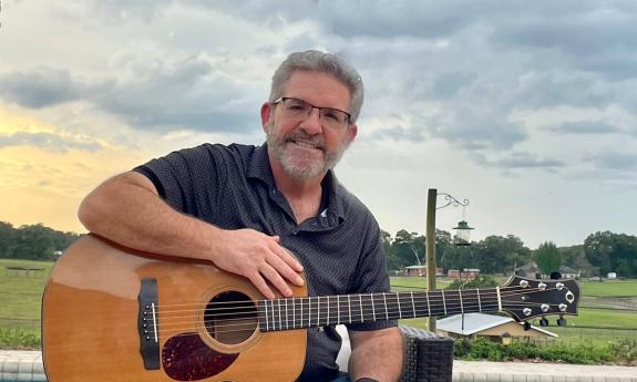 Award winning songwriter Scott Jackson with his guitar