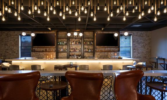 The bar and the nearby high-top seating in the Renaissance Historic Downtown Hotel in St. Augustine