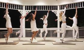 Six dancers in white, dancing in unison in the gazebo in St. Augustine