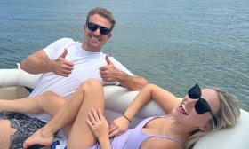 A couple lounging in the sun aboard a Tiki Island Adventures charter trip