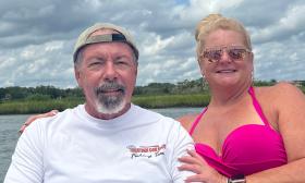 Two people dressed for the sun, aboard a small boat in St. Augustine