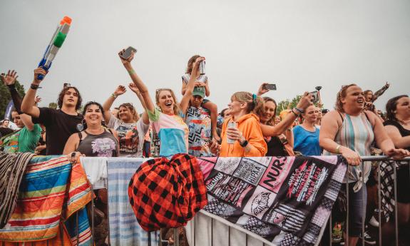 A photo of a section of the crowd at an afternoon event, on a cool, grey day. Photo taken by Melissa Maracarelli