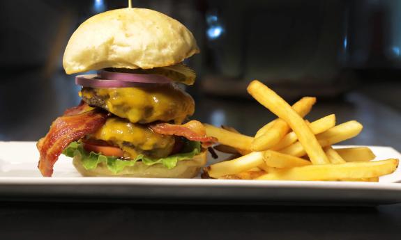 Stacked-high cheeseburger with bacon and fresh vegetables from GAS in St. Augustine