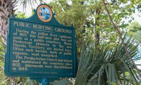 A marker placed by the state of Florida with historical information about the Huguenot Cemetery