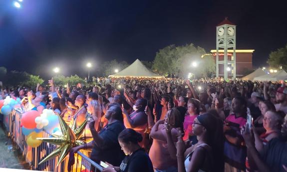 A crowd, standing in front of a stage at night in Palatka, near St. Augustine, Florida