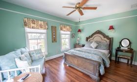 A pastel blue and green bedroom, cool and welcoming, in the Centennial House Bed and Breakfast in St Augustine