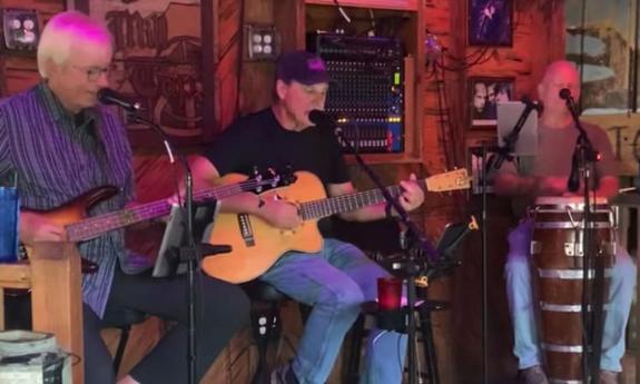 The JC Hatfield Trio, on bass, guitar, and congas, playing a gig at the Mill Top Tavern