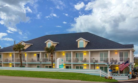 Ocean Sands Hotel viewed from A1A on a day with fluffy clouds and blue skies