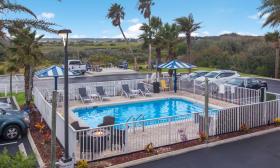 The pool at Ocean Sands Inn as seen from the second floor balcony on a beautiful day