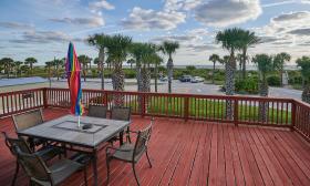 The red-wood stained deck with an umbrella table at OceanView Inn, Vilano Beach, St. Augustine