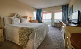A guest room at OceanView in Vilano Beach, with large windows and a view of the Atlantic Ocean