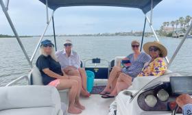 Four women in the stern of a deck boat, cruising in the waters off St. Augustine