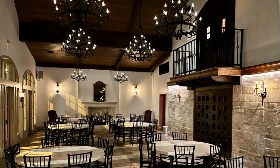 This 9 Aviles Event Space arranged for an intimate gathering with lit chandeliers and wall sconces